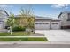 Charming single-story home with a well-manicured lawn and a two-car garage at 3022 Merlin Dr, Brighton, CO 80601