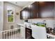 Well-lit home office featuring dark cabinetry, white countertops, and a gray painted wall at 3022 Merlin Dr, Brighton, CO 80601