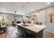 Open-concept design showcases the kitchen island with sink and seamless access to the inviting living area at 3022 Merlin Dr, Brighton, CO 80601