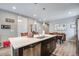 Well-lit kitchen with modern appliances, a functional island with sink, and easy access to the dining space at 3022 Merlin Dr, Brighton, CO 80601