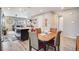 Bright kitchen with a breakfast bar, modern cabinetry, and seamless flow to the living and dining areas at 3022 Merlin Dr, Brighton, CO 80601