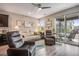 Bright and open living room with sliding doors to the patio and seamless transition to the kitchen at 3022 Merlin Dr, Brighton, CO 80601