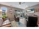 Spacious living room with access to an outdoor patio, comfortable seating, and a TV for entertainment at 3022 Merlin Dr, Brighton, CO 80601