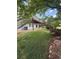 Lush backyard with deck access, surrounded by green grass and beautiful landscaping at 15502 E Flower Mound Pl, Parker, CO 80134