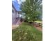 Grassy backyard with stairs, providing a serene outdoor space next to lush greenery and a large tree at 15502 E Flower Mound Pl, Parker, CO 80134