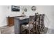 Finished basement features a bar with dark cabinets, bar seating and decorations at 15502 E Flower Mound Pl, Parker, CO 80134