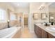 Luxurious bathroom with dual vanities, a soaking tub, and a glass-enclosed shower at 15502 E Flower Mound Pl, Parker, CO 80134