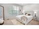 Cozy bedroom with a large window, plush carpet, and decorative headboard at 15502 E Flower Mound Pl, Parker, CO 80134