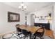 Inviting dining room with hardwood floors, a wooden table, and unique decorative elements at 15502 E Flower Mound Pl, Parker, CO 80134