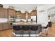 Well-equipped kitchen featuring granite countertops, a curved island with seating, and stainless steel appliances at 15502 E Flower Mound Pl, Parker, CO 80134
