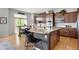 Bright kitchen features stainless appliances, an island with seating, and plenty of cabinet space at 15502 E Flower Mound Pl, Parker, CO 80134