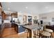 Open-concept kitchen showcasing an island, barstool seating, stainless appliances, and a cozy fireplace at 15502 E Flower Mound Pl, Parker, CO 80134