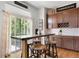 Stylish kitchen breakfast nook featuring seating for three and sliding glass doors to a deck or yard at 15502 E Flower Mound Pl, Parker, CO 80134