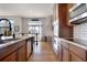 Modern kitchen with stainless appliances, a center island, and beautiful hardwood flooring at 15502 E Flower Mound Pl, Parker, CO 80134