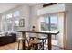 Kitchen area offering a breakfast bar with seating, connecting to a living space with large windows at 15502 E Flower Mound Pl, Parker, CO 80134