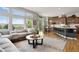 Open-concept living area showcasing a kitchen, connecting to a comfortable living room with abundant natural light at 15502 E Flower Mound Pl, Parker, CO 80134