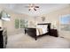 Serene bedroom boasts a tray ceiling, soft carpet, and large windows for natural lighting at 15502 E Flower Mound Pl, Parker, CO 80134