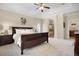 Relaxing bedroom with a king-size bed, soft lighting, and an open doorway to the bathroom at 15502 E Flower Mound Pl, Parker, CO 80134
