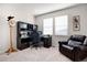 Comfortable home office featuring a sleek desk setup, cozy leather chair, and natural light from a window at 15502 E Flower Mound Pl, Parker, CO 80134