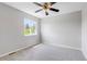 Neutrally decorated bedroom featuring new windows, ceiling fan, and plush carpet at 1526 Braewood Ave, Littleton, CO 80129