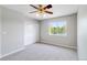 Bright bedroom with neutral walls, soft carpeting, large window, and closet at 1526 Braewood Ave, Littleton, CO 80129