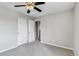 Bedroom featuring plush carpeting, closet, and bright neutral wall paint at 1526 Braewood Ave, Littleton, CO 80129