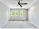 Spacious carpeted bedroom featuring modern ceiling fan and bright double windows at 1526 Braewood Ave, Littleton, CO 80129