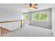 Upstairs bonus room with a ceiling fan, large window, and new carpet is move-in ready at 1526 Braewood Ave, Littleton, CO 80129