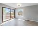 Bright living room featuring sliding glass doors leading to an outdoor deck and wood-look flooring at 1526 Braewood Ave, Littleton, CO 80129