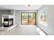 Sun-filled living room featuring a modern fireplace, windows, and sliding glass doors to the backyard at 1526 Braewood Ave, Littleton, CO 80129