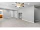 Large living room featuring modern ceiling fan, plush carpets, and neutral paint at 1526 Braewood Ave, Littleton, CO 80129