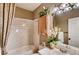 Cozy bathroom with a shower-tub combo, decorative flowers, and a lovely vanity mirror at 12914 Grant Cir # C, Thornton, CO 80241