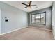 Bedroom with neutral walls, carpet, large window and a ceiling fan at 12914 Grant Cir # C, Thornton, CO 80241