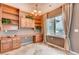 Bright dining room with built-in shelving, desk, and a large window overlooking a snowy scene at 12914 Grant Cir # C, Thornton, CO 80241