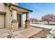 Welcoming front porch with stone-clad columns and a well-maintained entrance; lovely flowering trees in the yard at 12914 Grant Cir # C, Thornton, CO 80241