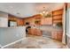 Spacious kitchen with wooden cabinets, stainless appliances, breakfast bar, and built-in desk space at 12914 Grant Cir # C, Thornton, CO 80241