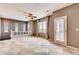 Open-concept living room features large windows, neutral paint, and elegant tile flooring for a bright and airy atmosphere at 12914 Grant Cir # C, Thornton, CO 80241