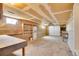 Unfinished basement with workbench, shelving, and garage door access at 8005 Emerald Ln, Broomfield, CO 80020