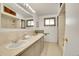 Spacious bathroom with dual sinks, vanity, a large mirror, and shower at 8005 Emerald Ln, Broomfield, CO 80020