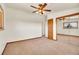 A view of a carpeted bedroom with natural light, mirrored closet, and ceiling fan at 8005 Emerald Ln, Broomfield, CO 80020