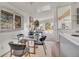 Dining room with a modern glass table, seating for four, and bright natural light at 8005 Emerald Ln, Broomfield, CO 80020