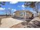 View of the exterior featuring a sunroom, brick facade, and mature trees at 8005 Emerald Ln, Broomfield, CO 80020