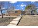 Charming brick home with a walkway leading to the front door at 8005 Emerald Ln, Broomfield, CO 80020