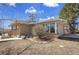 Charming brick home featuring a sunroom and well-manicured landscaping at 8005 Emerald Ln, Broomfield, CO 80020