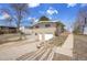 Ranch-style home on a hill with a one-car garage and brick facade at 8005 Emerald Ln, Broomfield, CO 80020