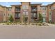 Modern building exterior with landscaping and walkways at 15274 W 64Th Ln # 206, Arvada, CO 80007