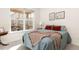 A comfortable bedroom features a large window with a view to the screened in porch at 4894 Bierstadt Loop, Broomfield, CO 80023