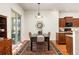 Bright dining room features a black table and a patterned rug, perfect for Gathering meals at 4894 Bierstadt Loop, Broomfield, CO 80023
