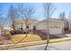 Inviting home exterior showcasing desert landscaping, brick accents, and an attached two-car garage at 4894 Bierstadt Loop, Broomfield, CO 80023