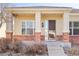 Inviting front porch with brick columns and a covered entrance at 4894 Bierstadt Loop, Broomfield, CO 80023